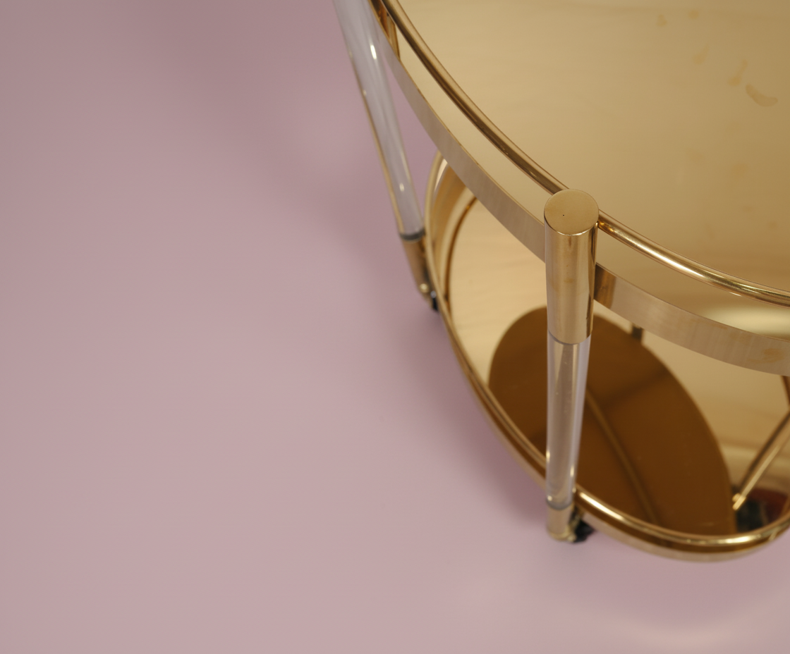 GLASS TROLLEY DC1013, angled view with oval brass shelves and acrylic posts