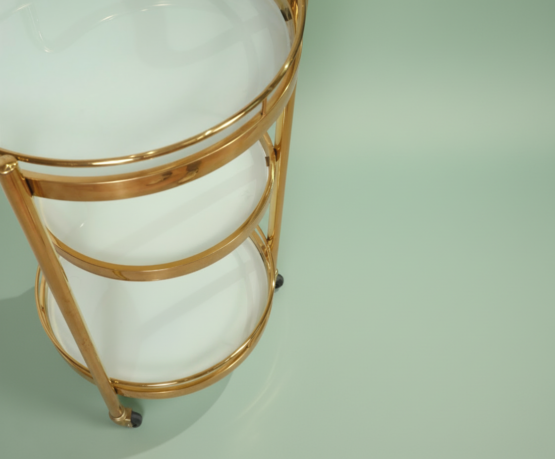 GLASS TROLLEY DC1036, angled view of a round two-tier brass and glass cart