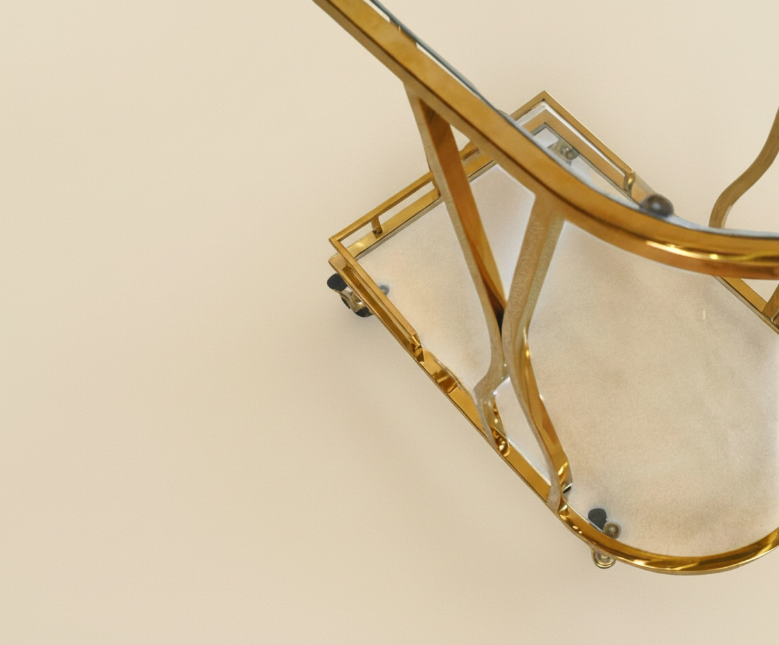 GLASS TROLLEY DC1053, angled view of an oval brass cart with glass shelves