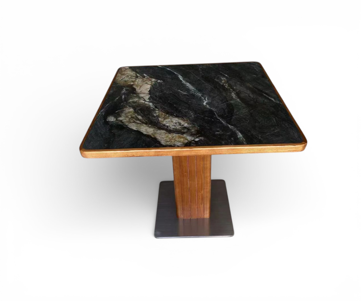 Granite edge cafe table in a restaurant with fluted panelling and an olive tree