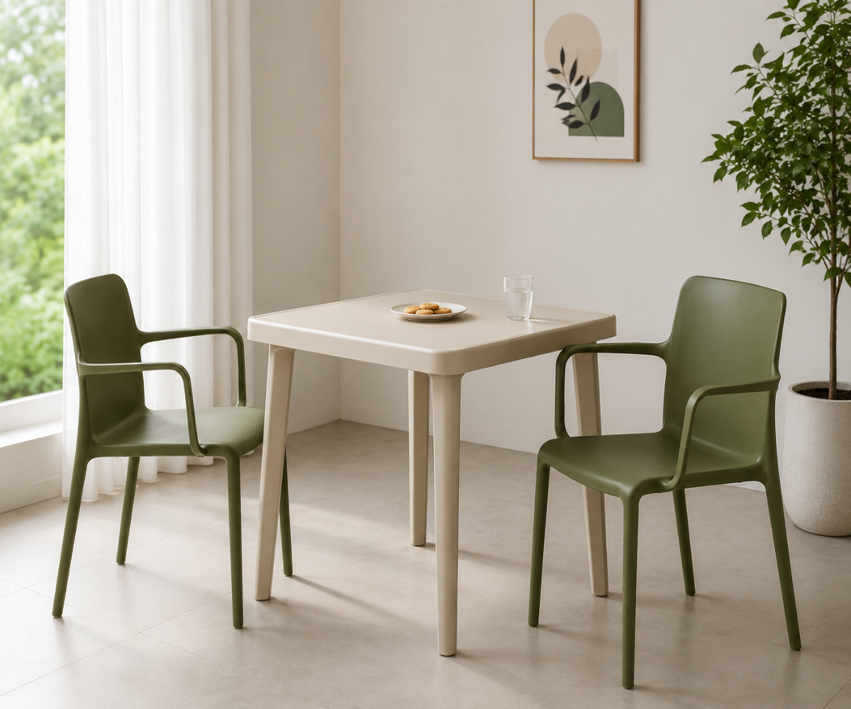 GREEN A651 dining chair, two chairs at a square table beside a potted tree