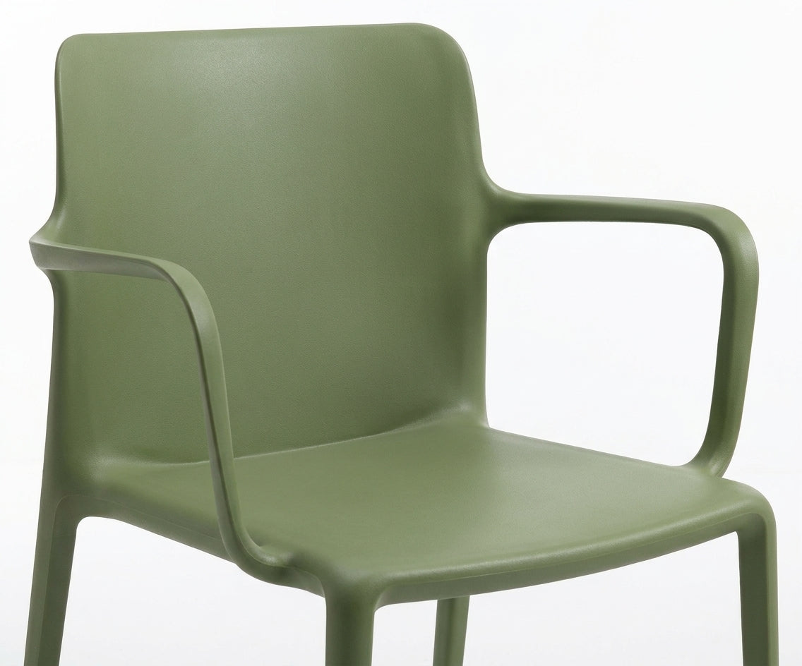 GREEN A651 dining chair, two chairs at a square table beside a potted tree