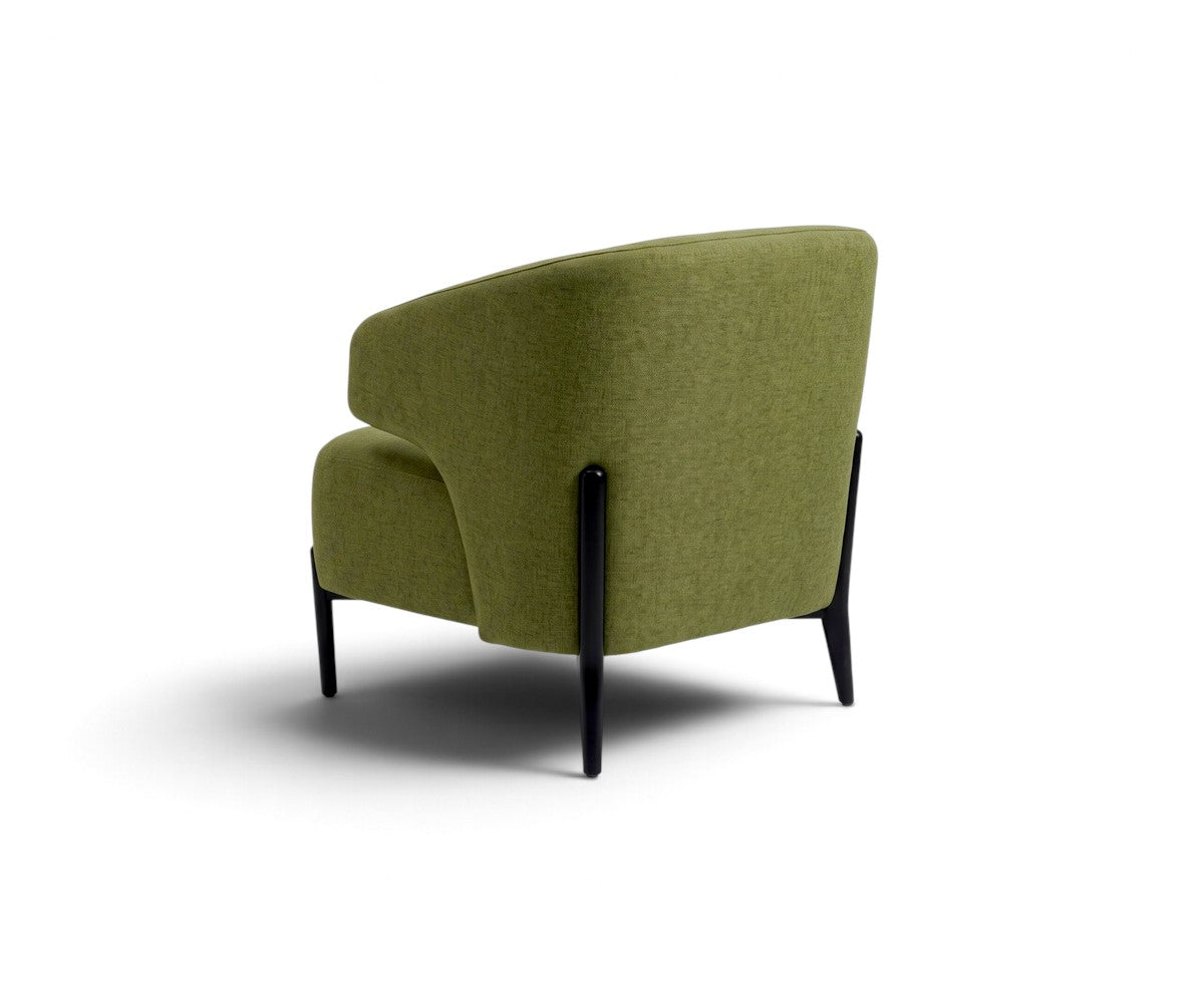 Green accent armchair with curved backrest styled in a luxurious, well-lit modern living room