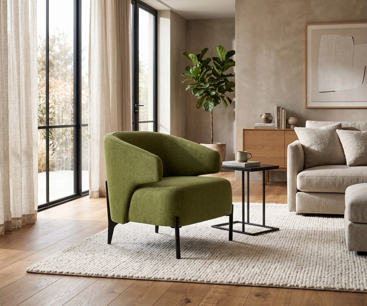 Green accent armchair with curved backrest styled in a luxurious, well-lit modern living room
