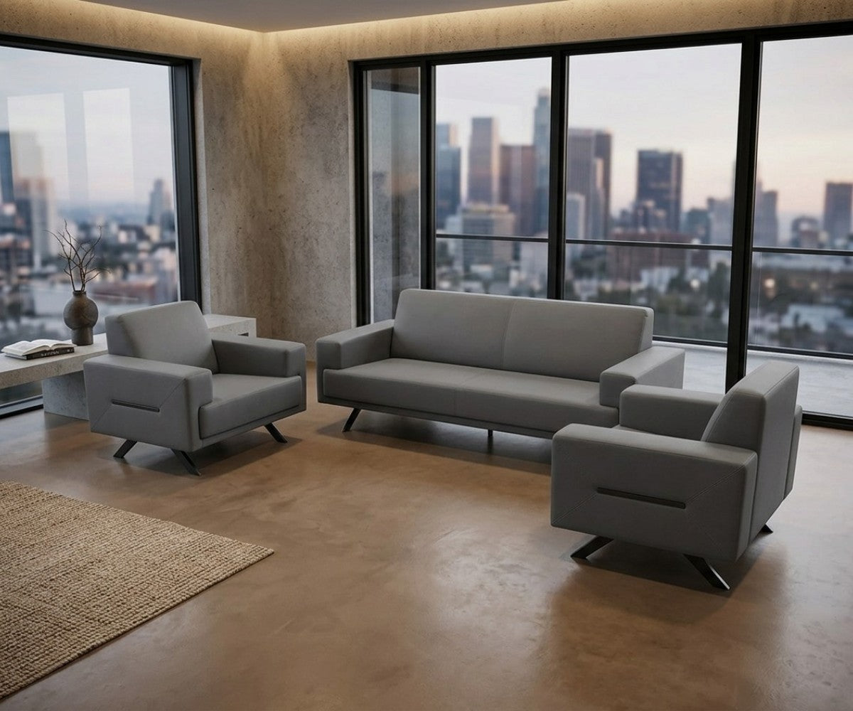 Grey three-piece sofa set with two matching armchairs in a luxurious, well-lit modern living room