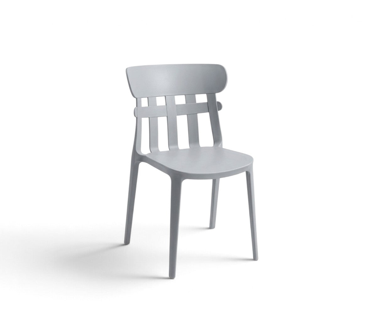 Light grey slat-back dining chair with curved top rail styled in a modern luxury dining room