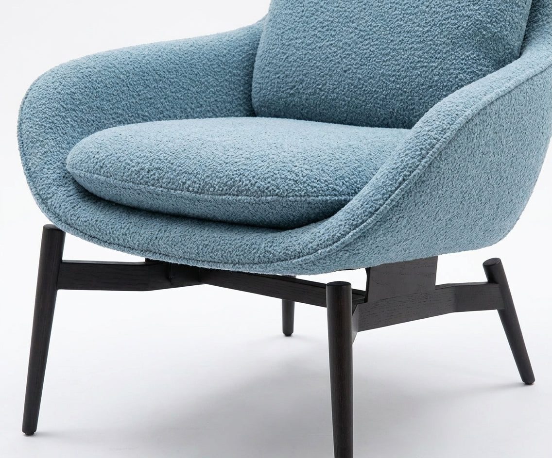 JYM1985 contemporary blue armchair beside a sofa in a bright living room