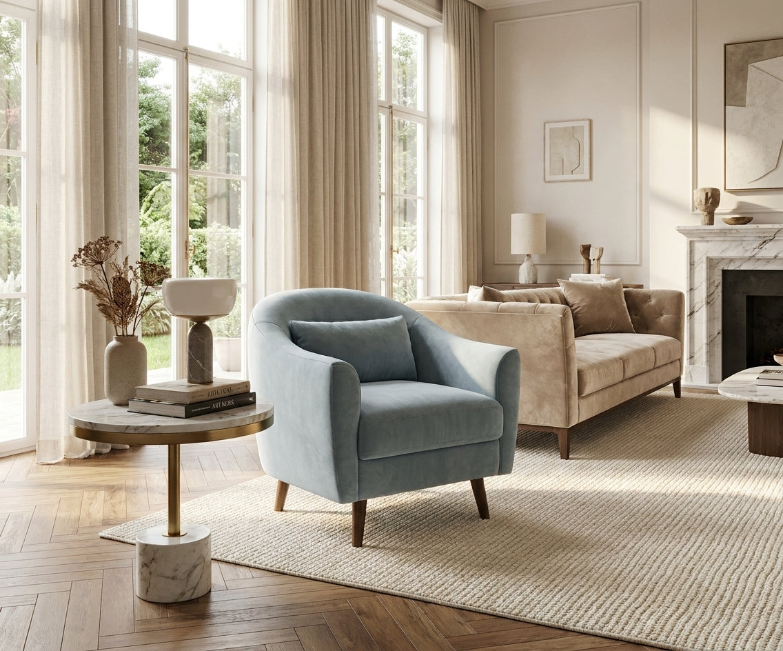 LC fabric lounge chair beside a sofa in a bright room with tall windows