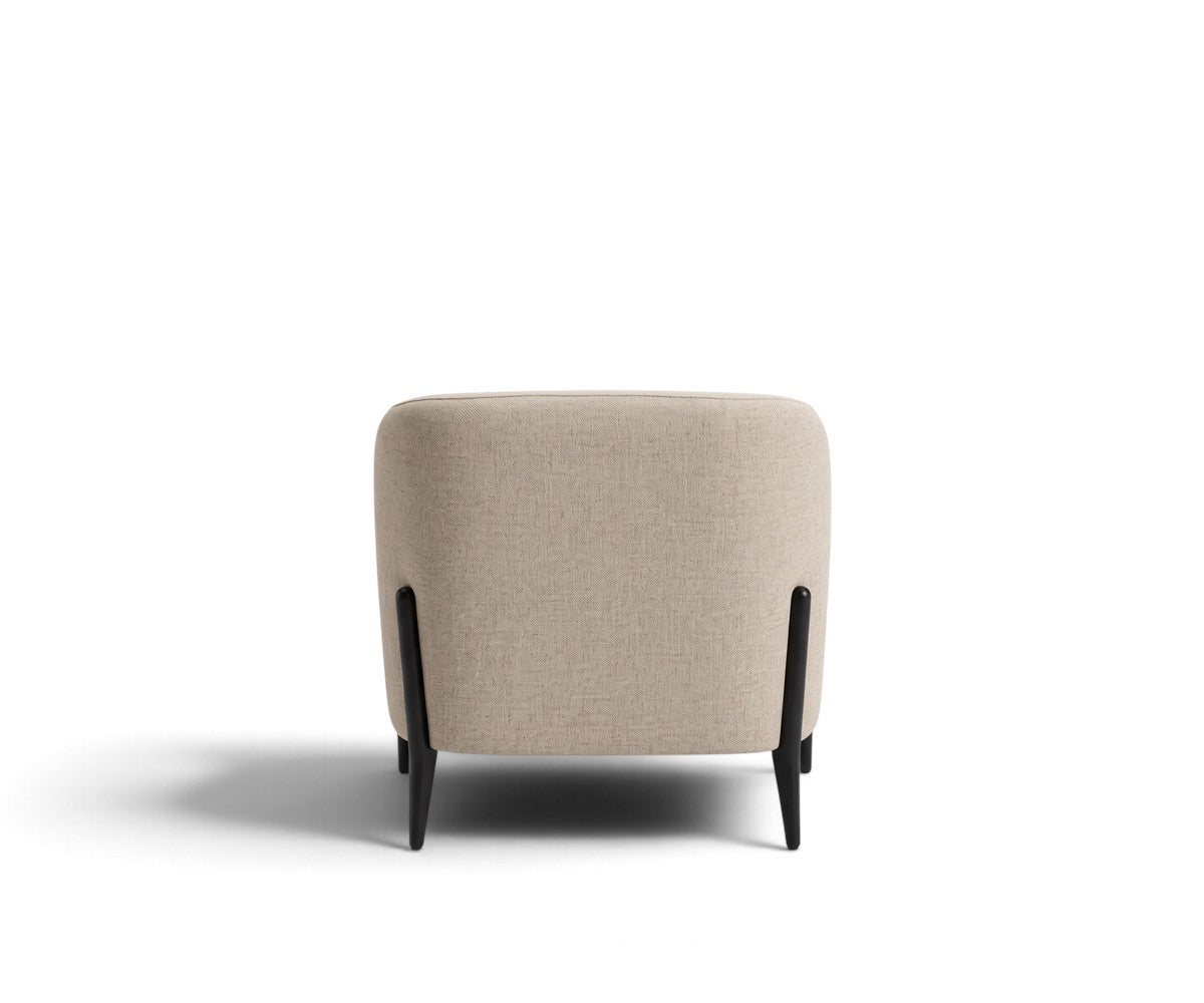 Light grey accent armchair with curved backrest styled in a luxurious, well-lit modern living room