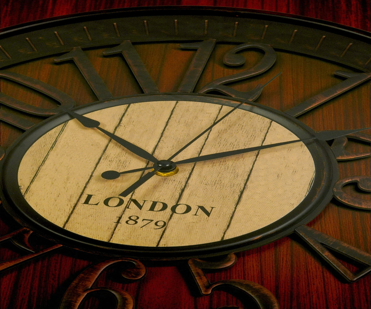 London 1879 bronze wall clock on a console beside a lit table lamp