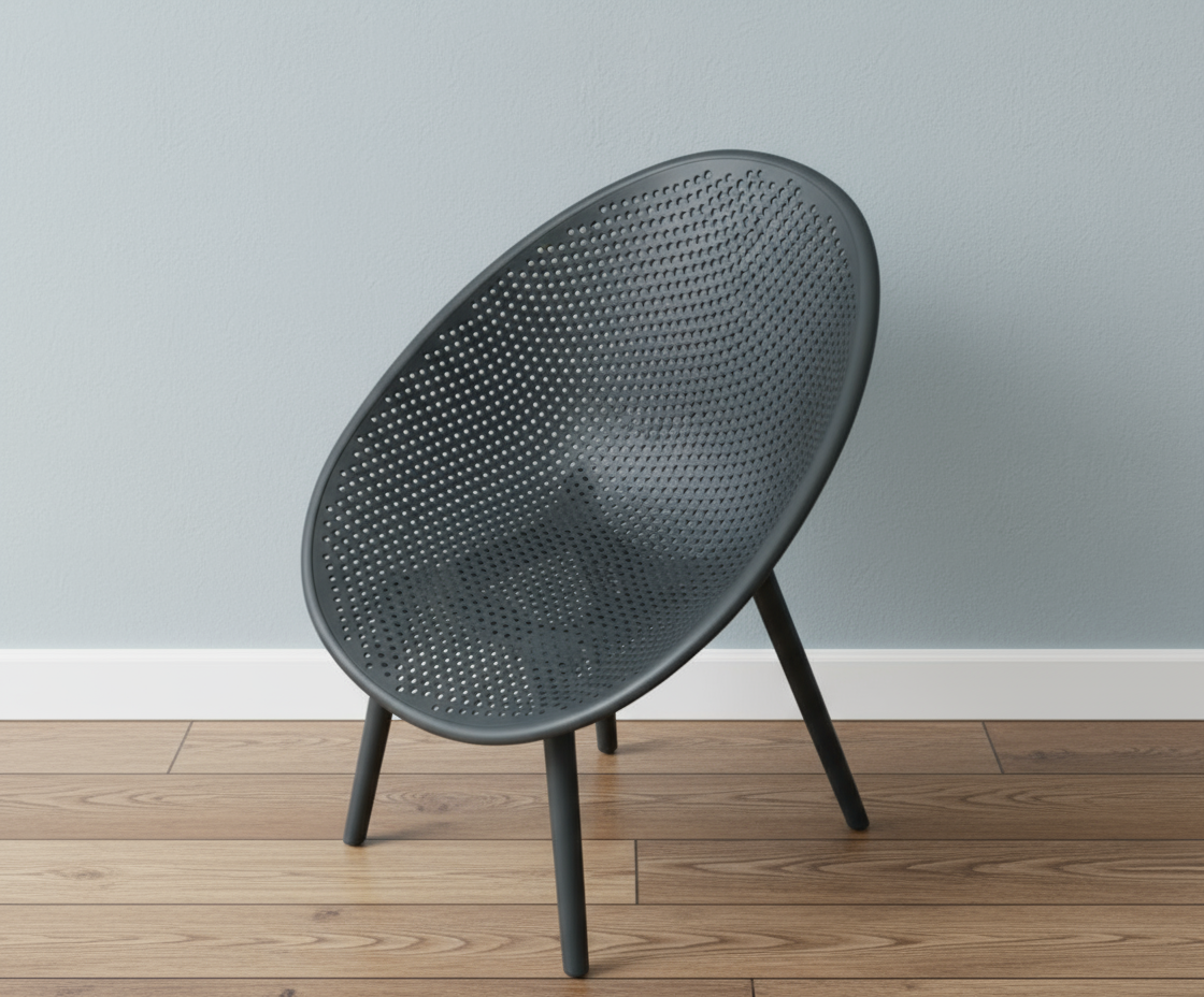 Lunar anthracite perforated designer chair, angled view on a wood floor