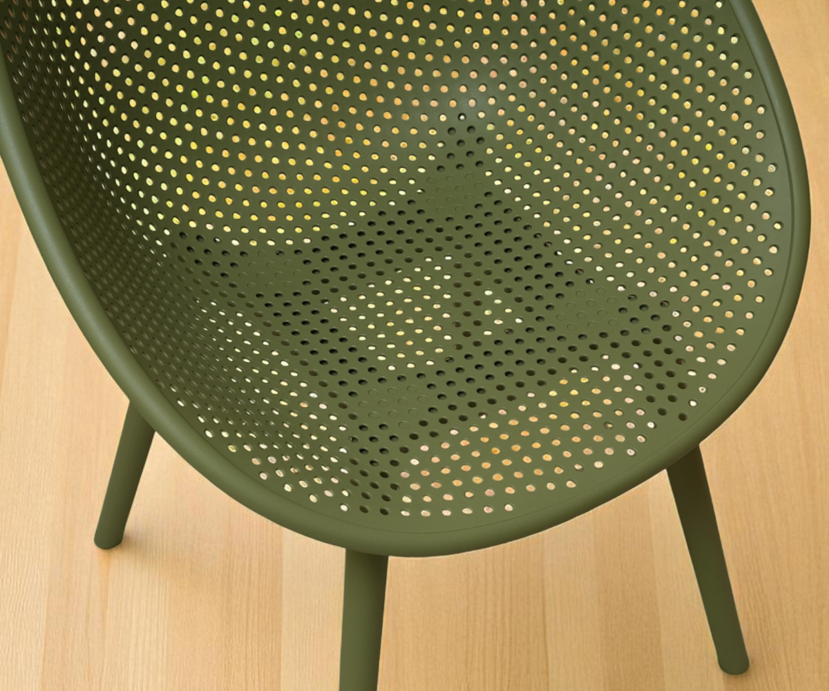 Lunar olive perforated designer armchair, angled view against a sage wall