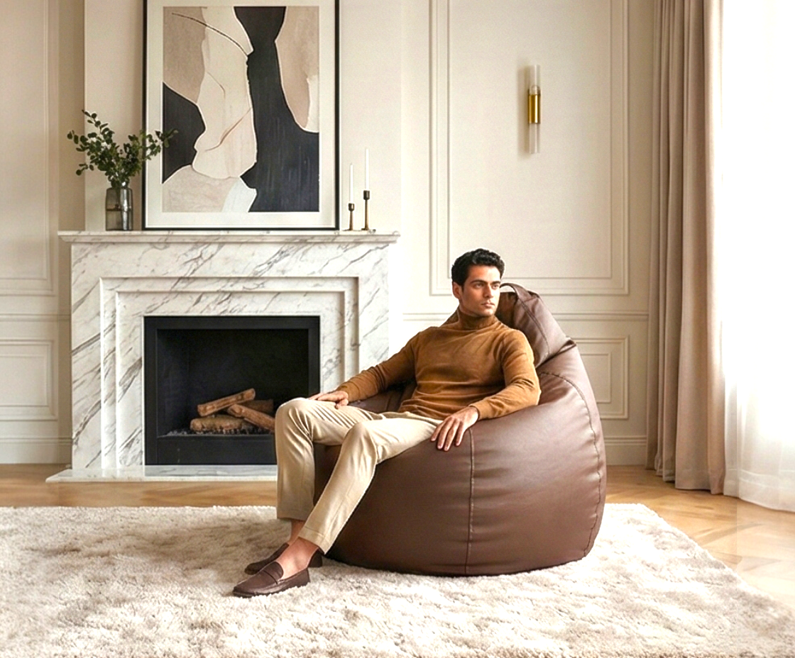 Luxury lounge bean bag in brown, with a person seated by a marble fireplace
