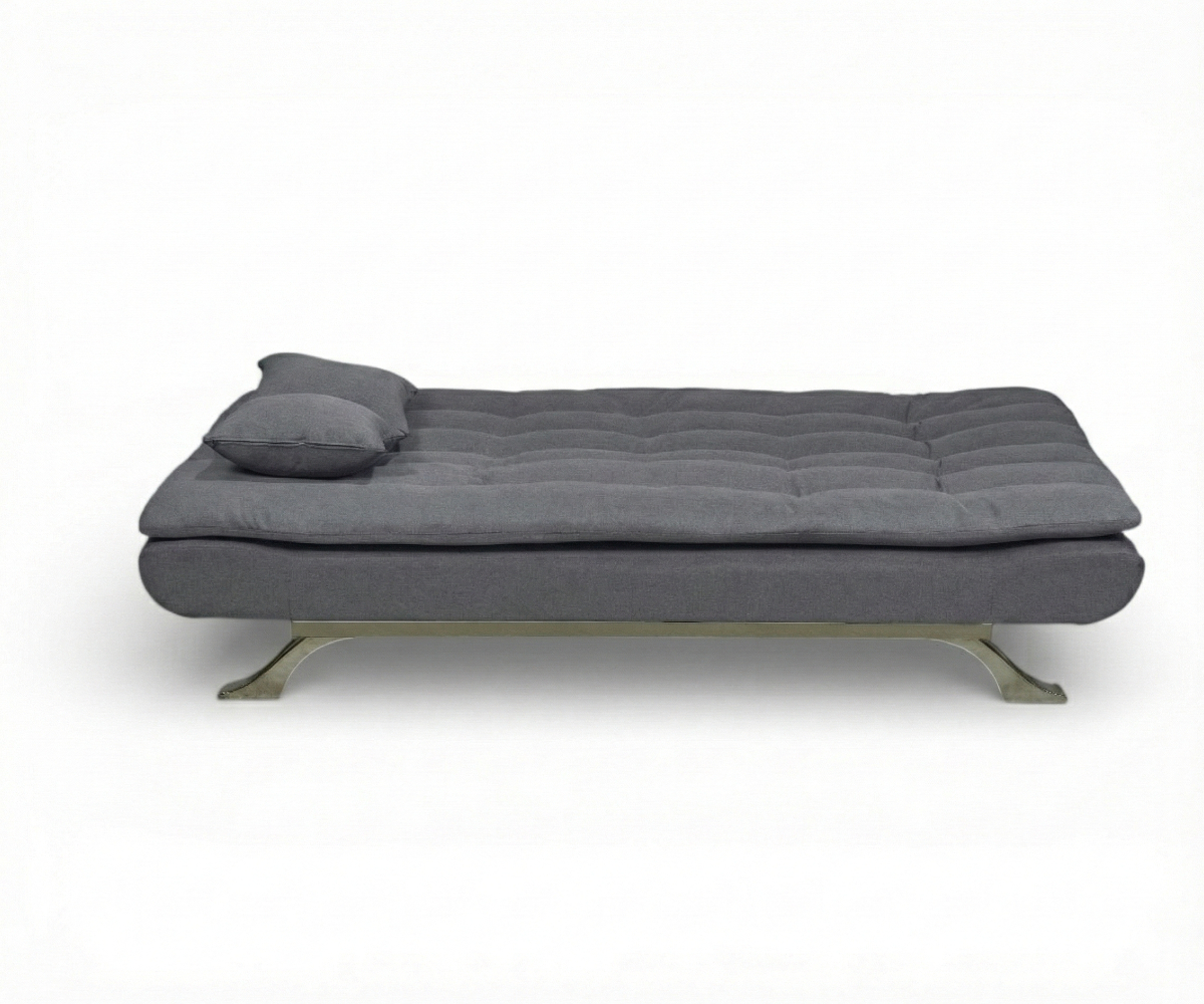 LV3364 armless sofa bed with scatter cushions against a terracotta wall