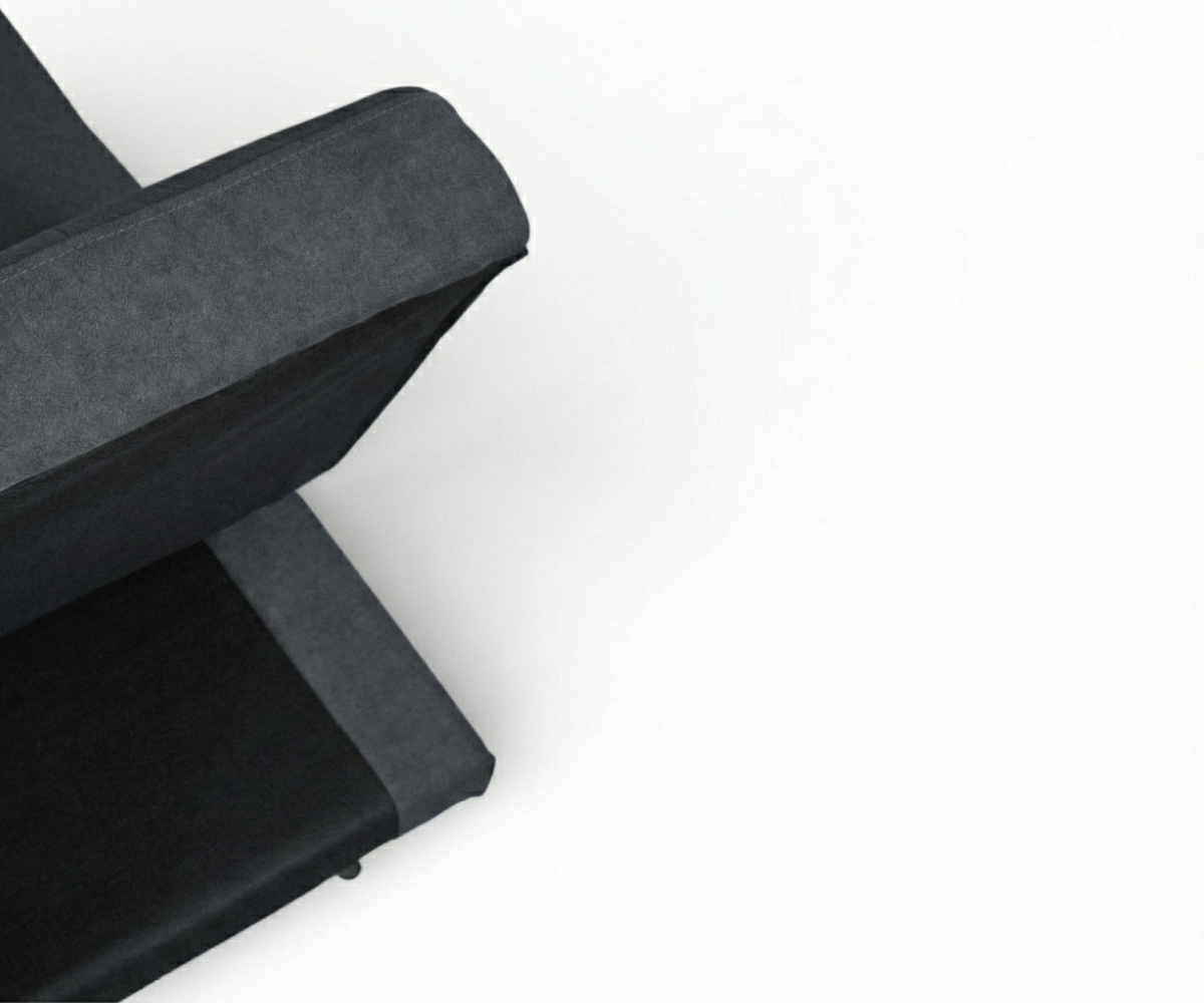 LV3785 charcoal click-clack sofa against a cream wall with a macrame hanging