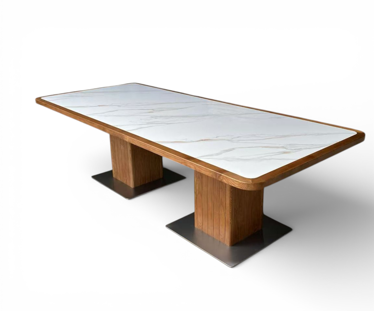 Marble column dining table in a warm-lit dining room with slatted panelling