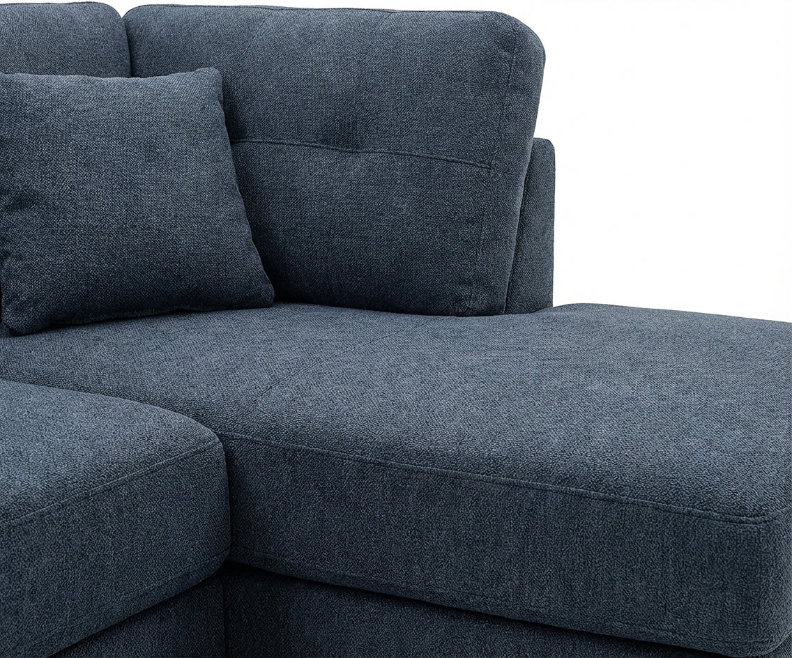 Mass blue corner sofa in a bright city-view living room