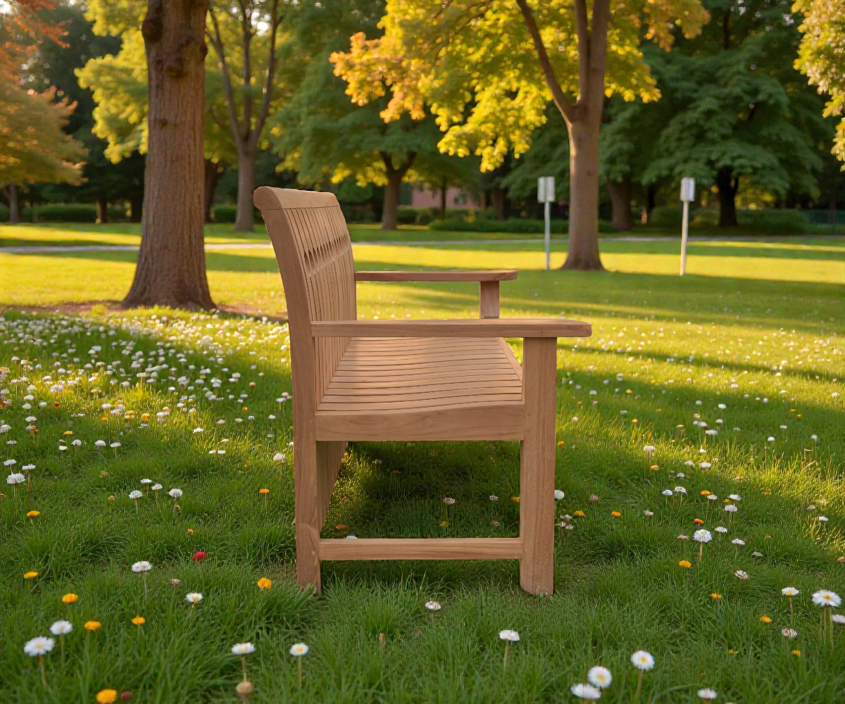 Maurice bench, teak garden bench on a lawn in front of daffodils