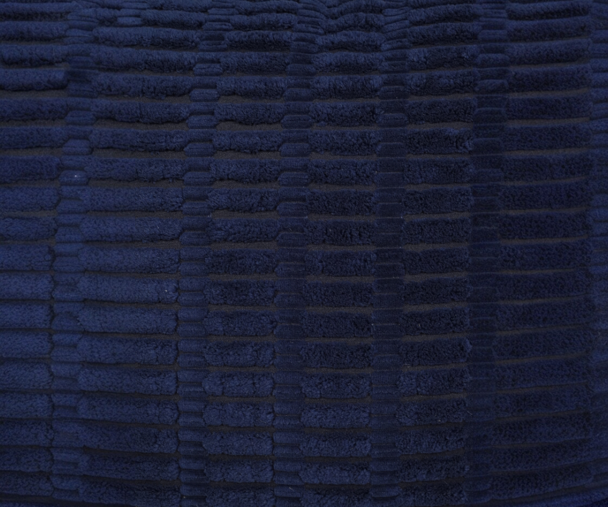 Navy ribbed velvet cushion cover on a teal sofa in a grey panelled room