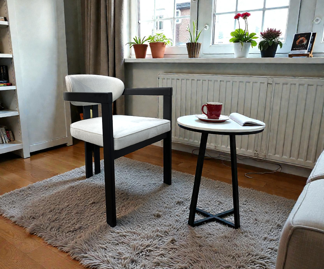NOTTE arm chair in a warm study beside a round side table and window plants