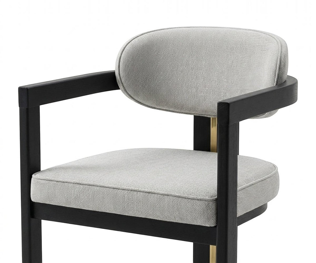 NOTTE elegant grey armchair beside a marble fireplace in a bright room