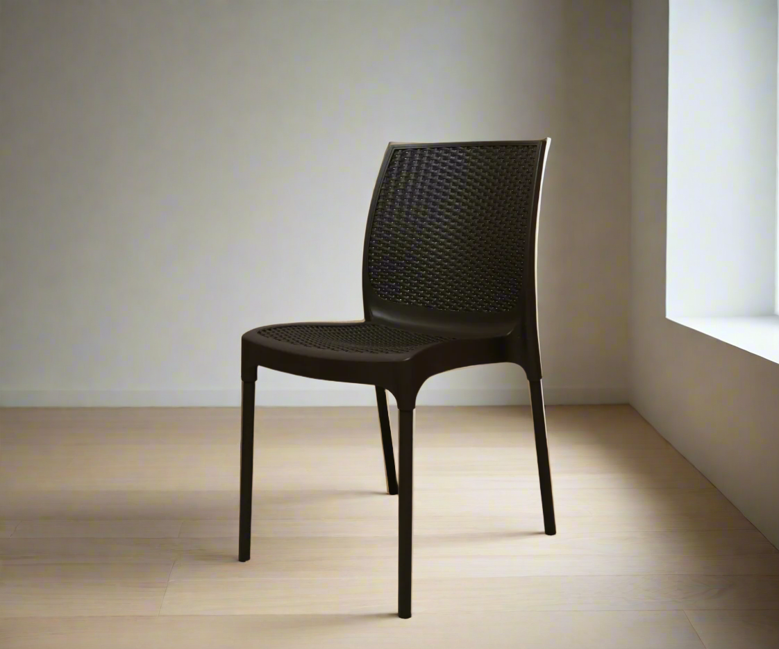 NVS-029-10 modern armless woven side chair, angled view in a bright corner