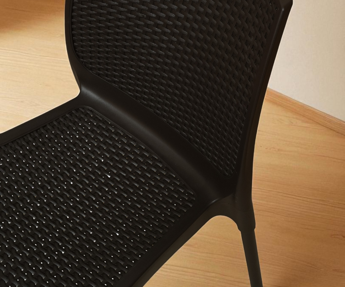 NVS-029-10 modern armless woven side chair, angled view in a bright corner