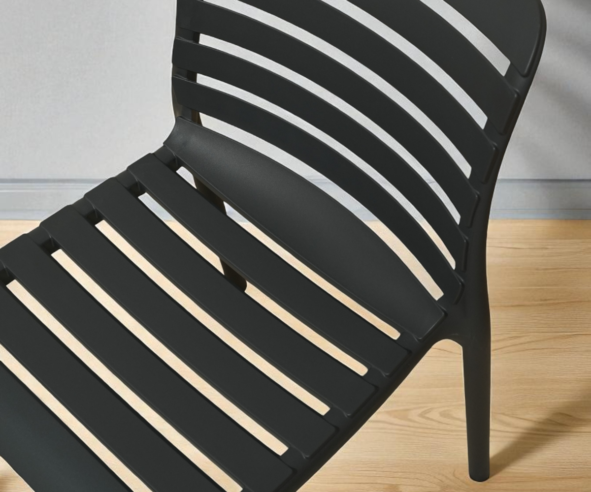 NVS-088-01 modern slatted side chair in black, angled view on a wood floor