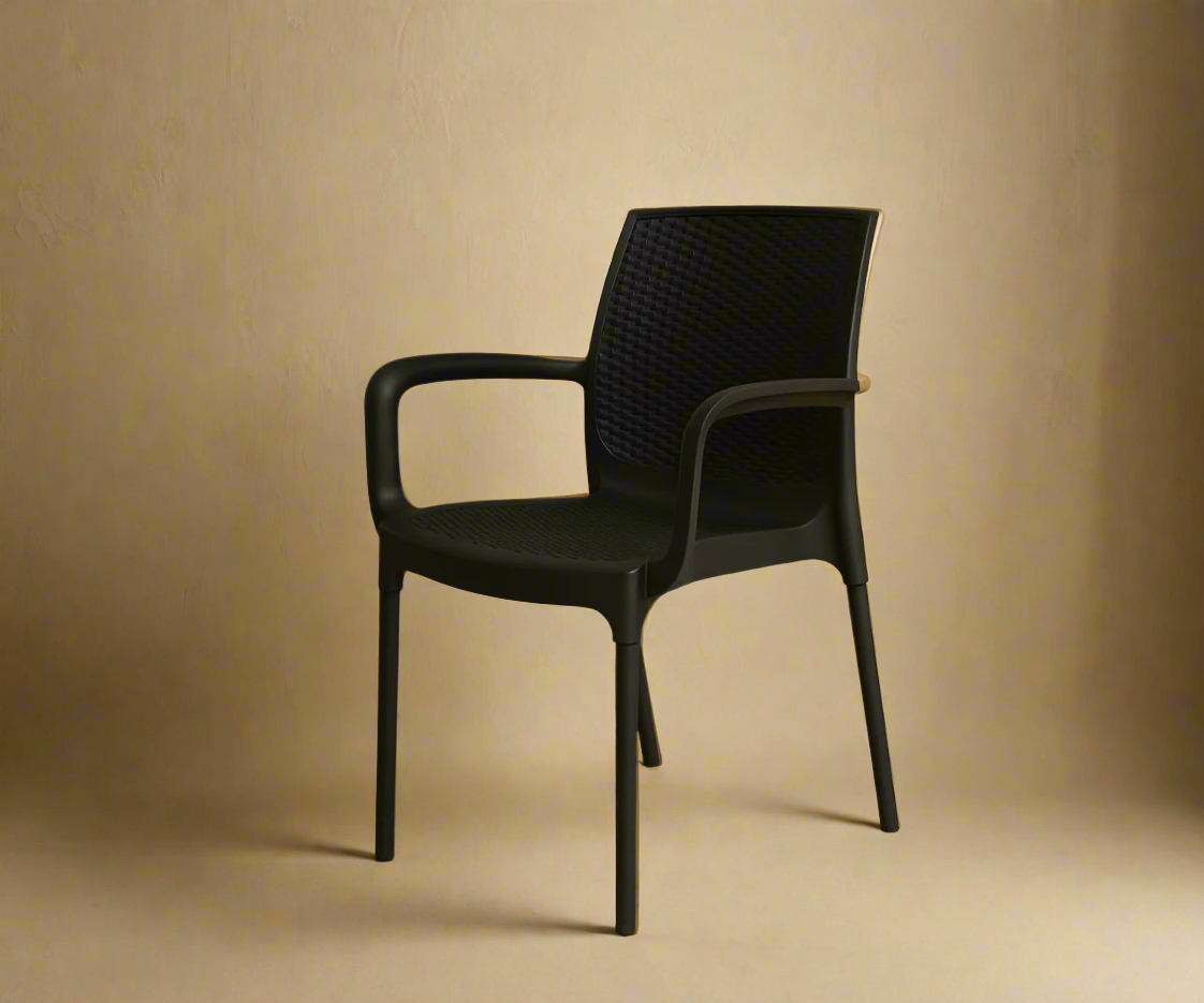 NVS-30-01 modern woven armchair in black, angled view against a warm wall