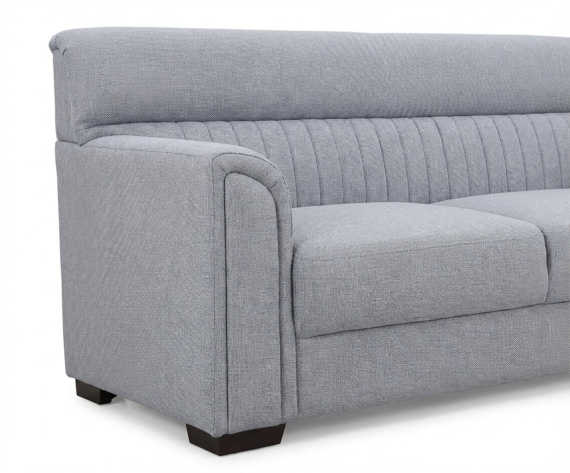 Opulent grey velvet sofa set in a bright room with arched windows