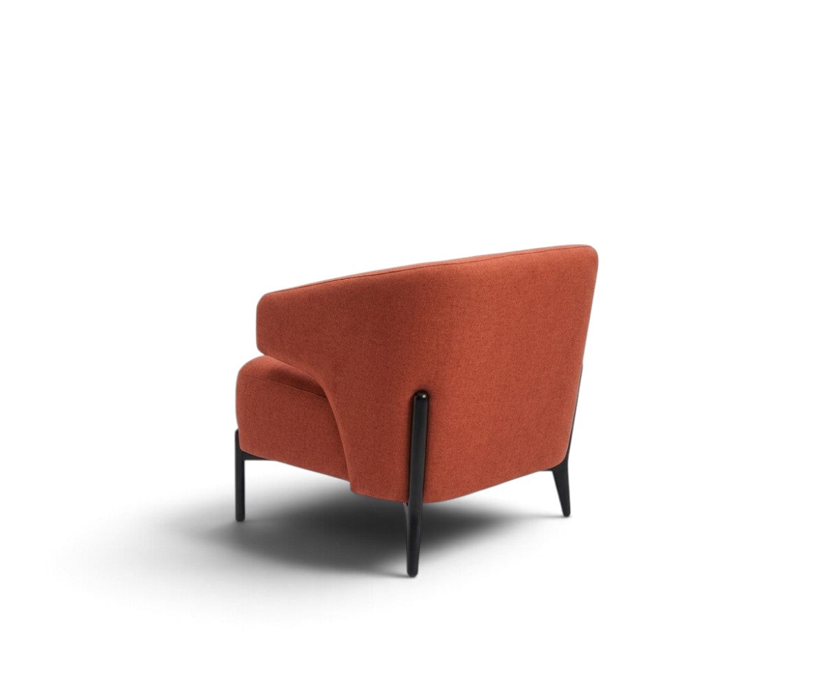Orange accent armchair with curved backrest styled in a luxurious, well-lit modern living room