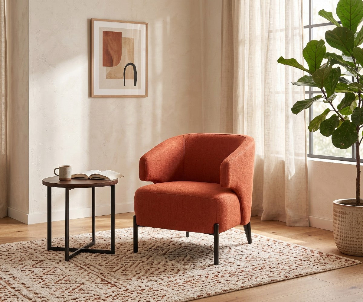 Orange accent armchair with curved backrest styled in a luxurious, well-lit modern living room