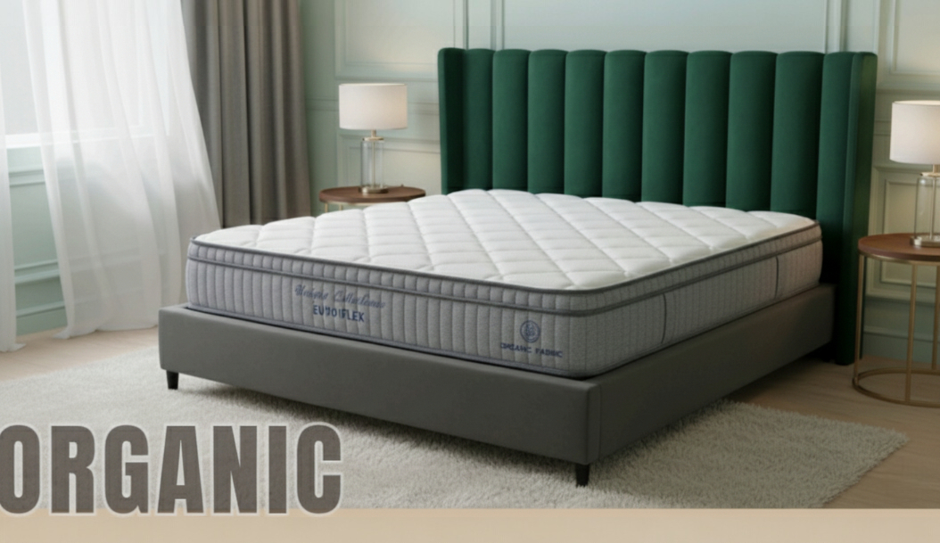 Organic pillow-top mattress with a grey border, in a bedroom with a green channel headboard