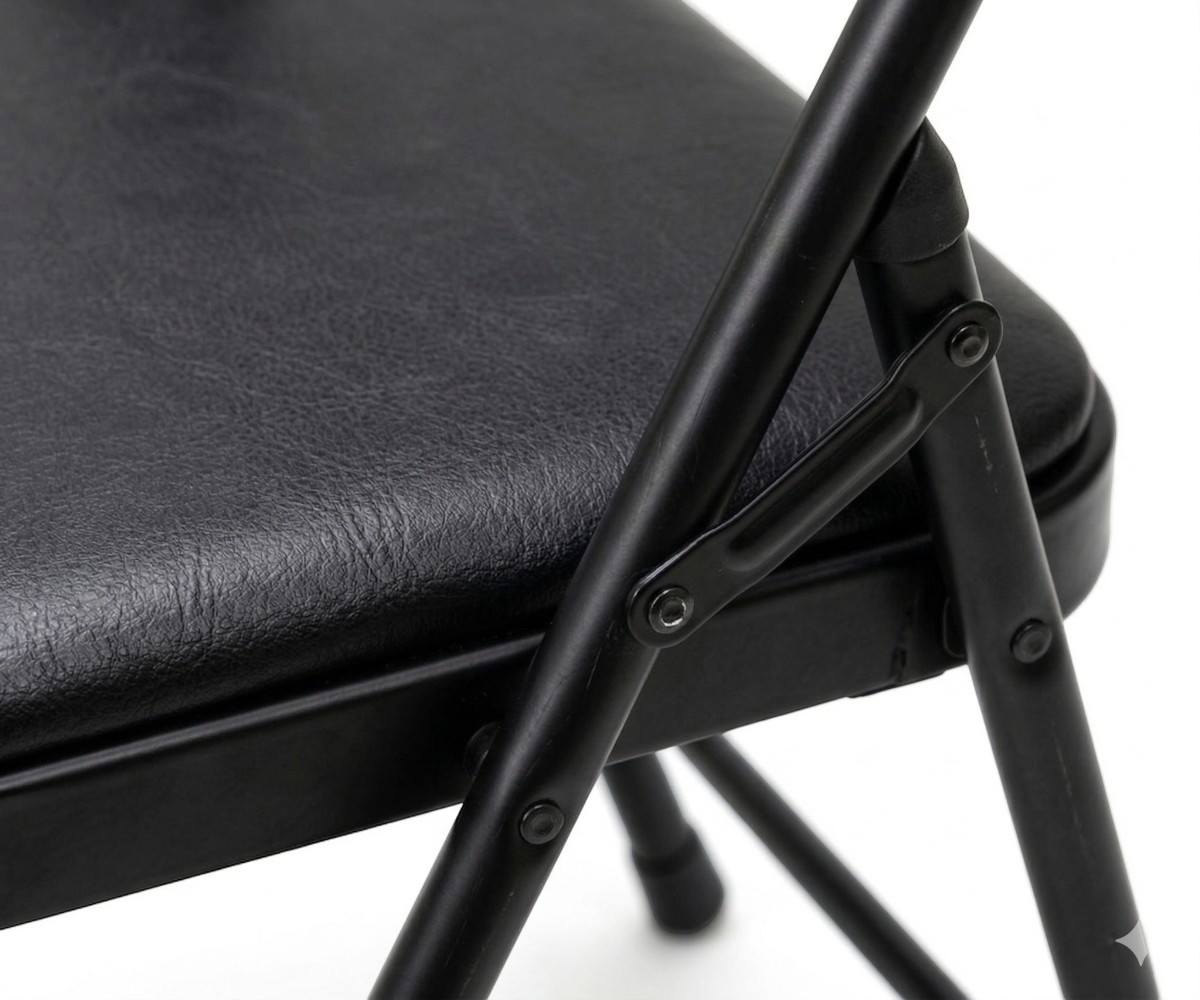 Padded foldable chair in black, angled view with a padded seat and back