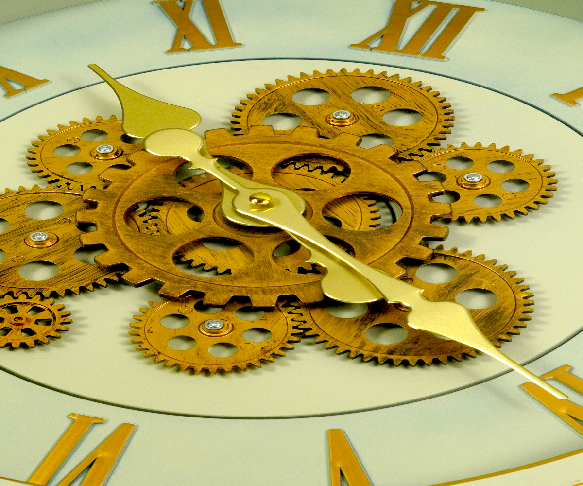 Sage gold gear skeleton wall clock outdoors beside tulips and blossom