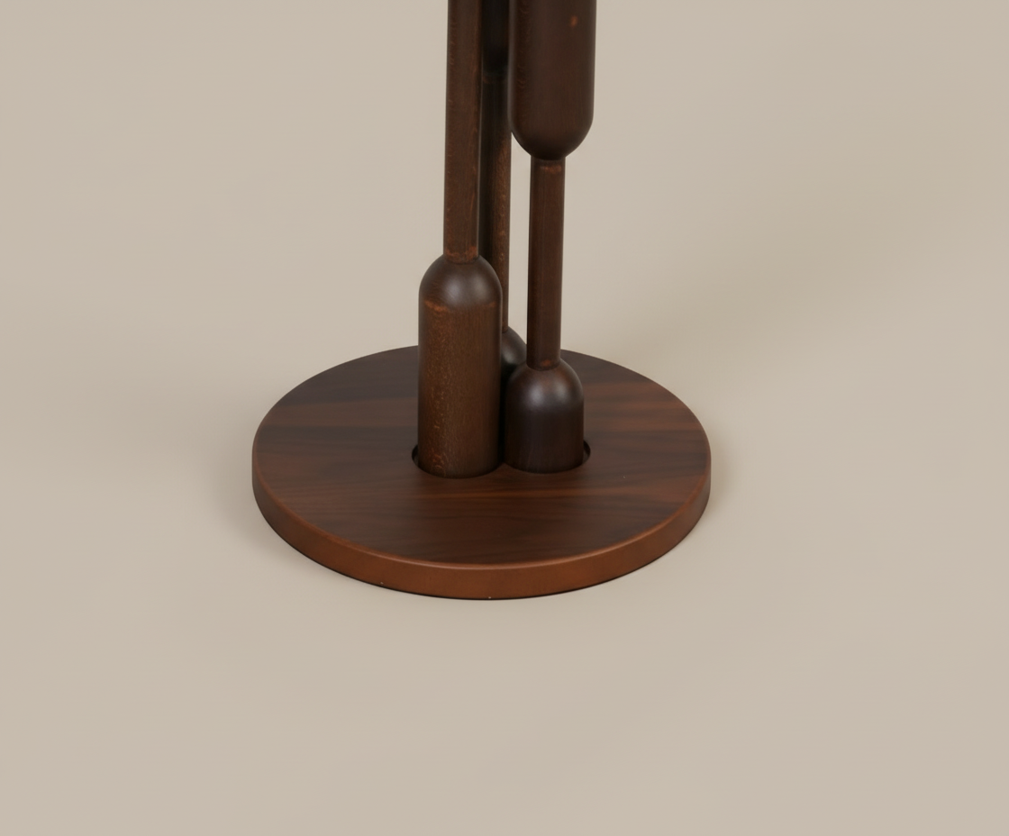 SENA dark walnut table, front view with a round top on turned legs