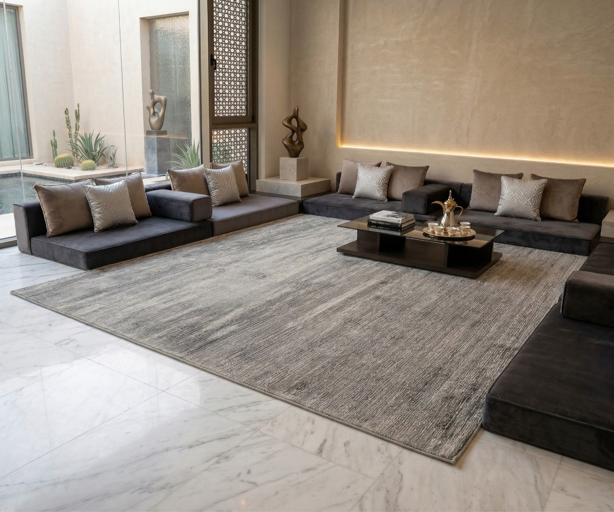 Silver distressed rug, 250x350 cm, in a modern majlis with dark floor seating