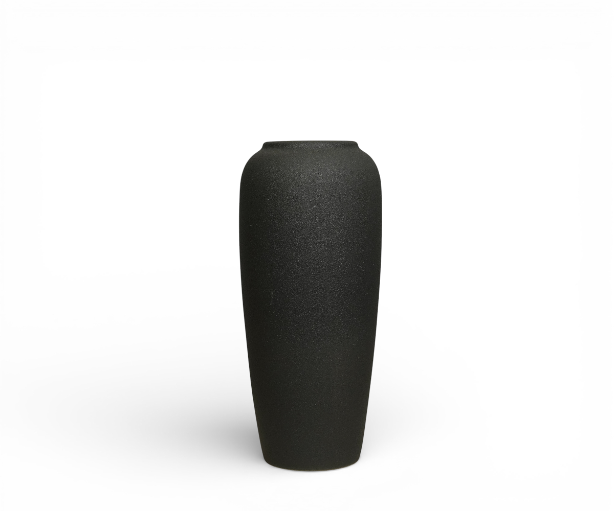 Tall black decorative vase A1007, styled with flowers on a dark panelled wall