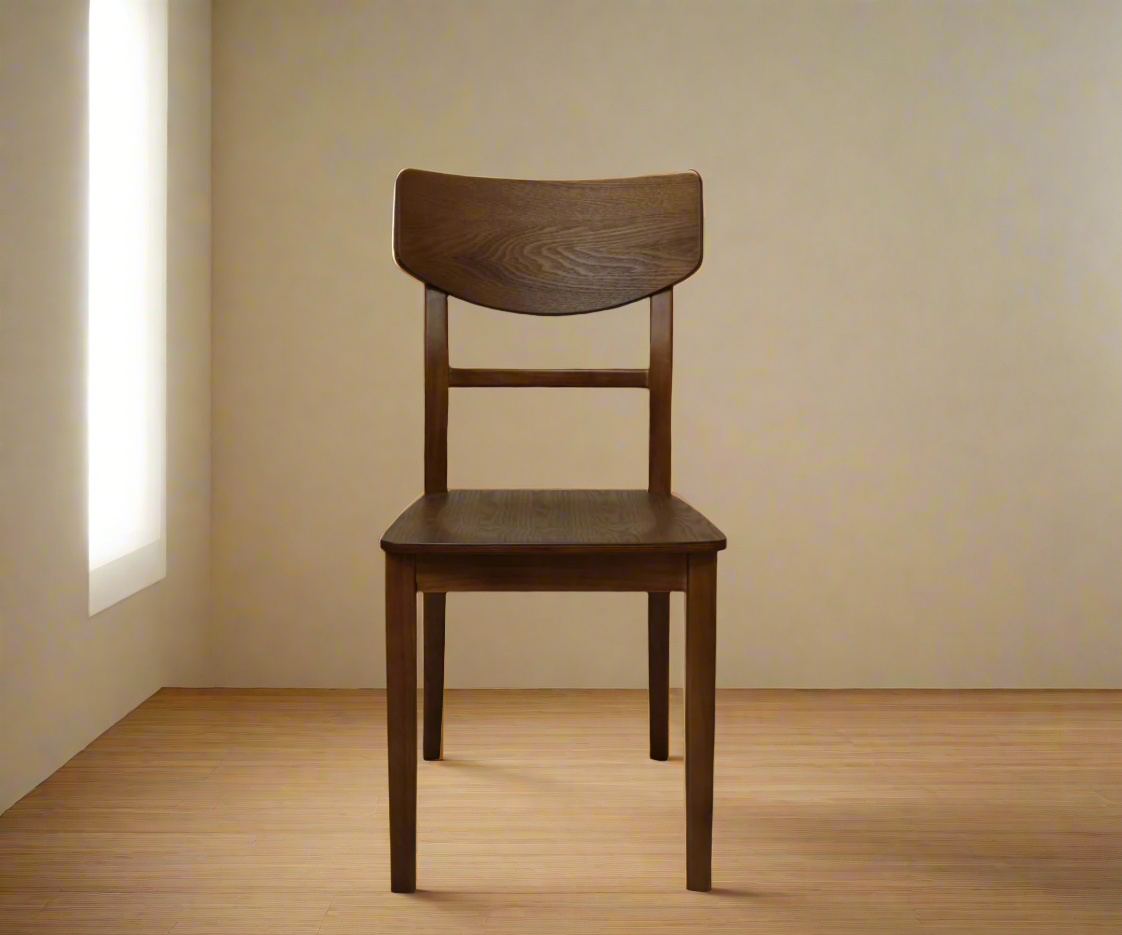 Wooden dining chair, front view in walnut in a sunlit corner