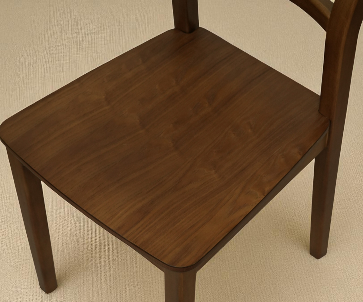 Wooden dining chair, front view in walnut in a sunlit corner